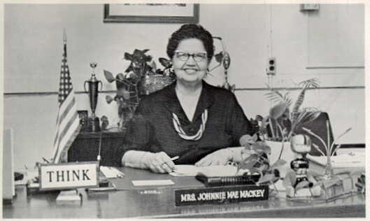 Miss Mackey at her desk